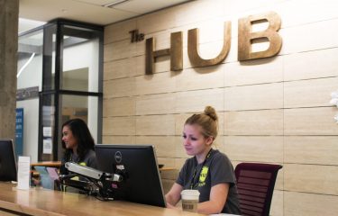 Students Working At The HUB Info Desk