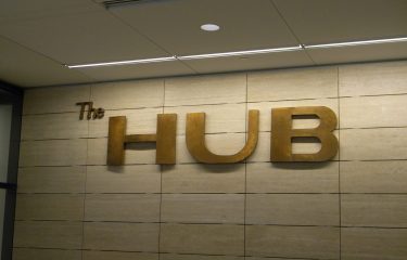 The HUB Sign Behind Info Desk