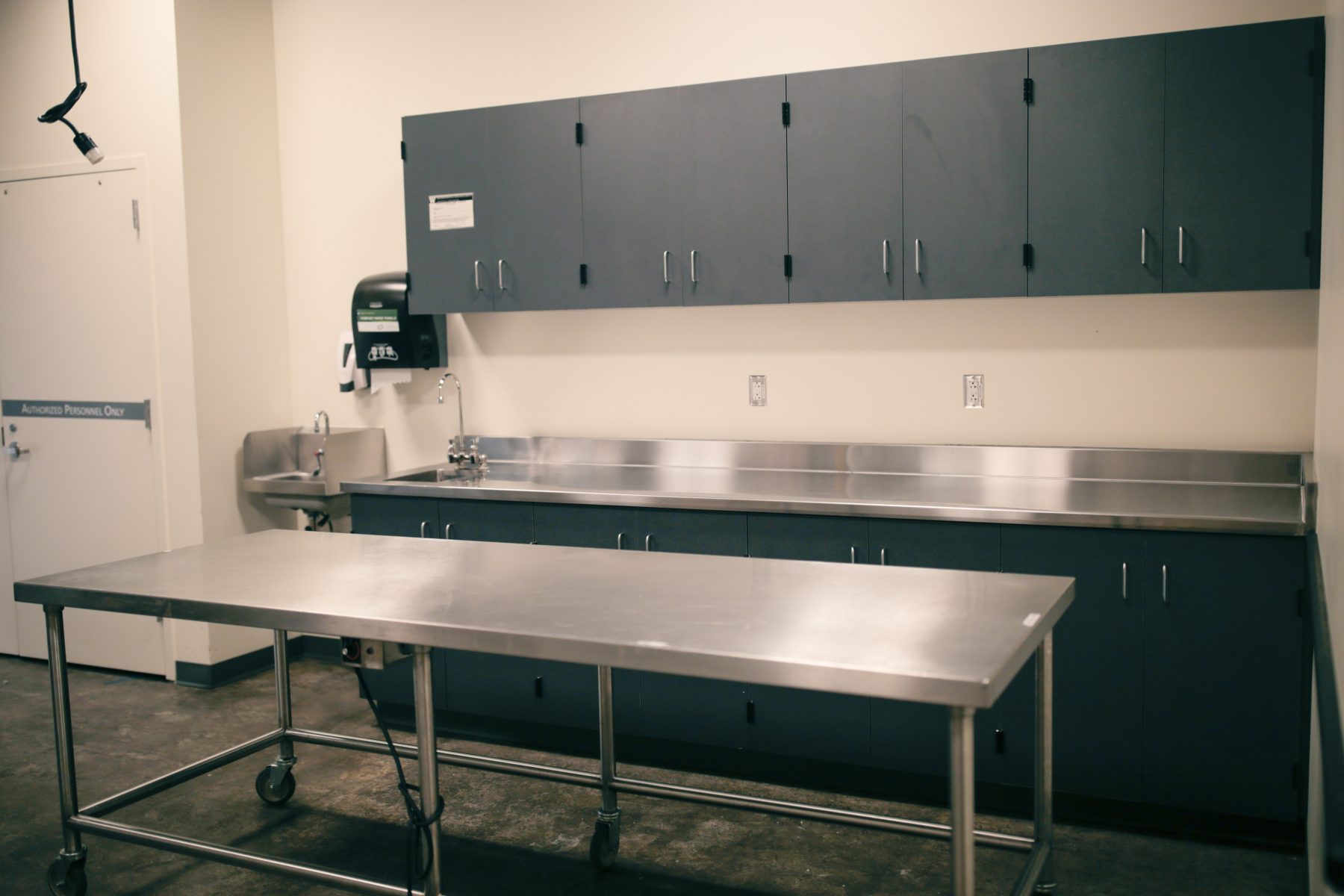 A handwashing sink and warming table are included with this Food Staging Area